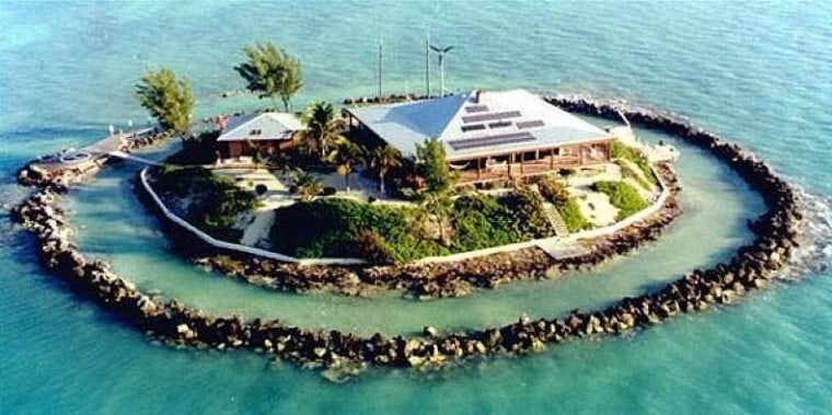 The 1.5-acre home is surrounded by a coral reef.