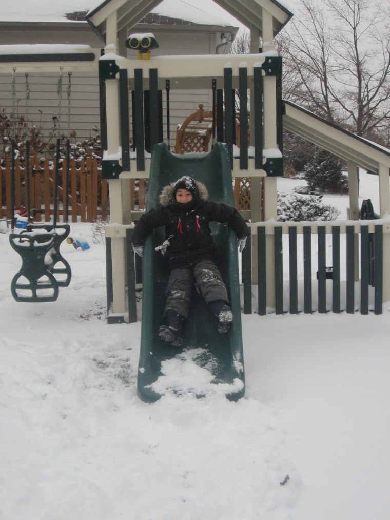 Michael, 5, doesn't let a little snow stop him from sliding in Warren, N.J.