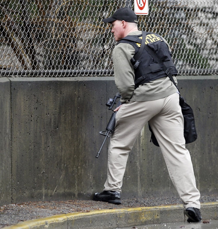 A Pennsylvania State Police officer keeps watch over the back of the Western Psychiatric Institute and Clinic of University of Pittsburgh Medical Center in Pittsburgh, Pennsylvania March 8, 2012. Two people were killed in a shooting at the University of Pittsburgh Medical Center on Thursday, and one of the dead was believed to be the shooter, the hospital said. REUTERS/ Jason Cohn (UNITED STATES - Tags: CIVIL UNREST CRIME LAW)