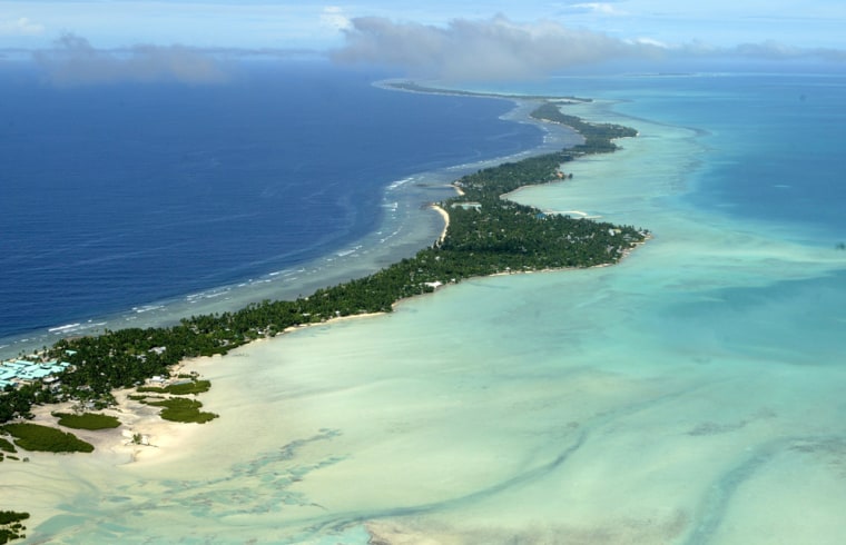 FILE - In this March 30, 2004 file photo, Tarawa atoll, Kiribati, is seen in an aerial view. Fearing that climate change could wipe out their entire Pacific archipelago, the leaders of Kiribati are considering an unusual backup plan: moving the populace to Fiji. Kiribati President Anote Tong told The Associated Press on Friday, March 9, 2012 that his Cabinet this week endorsed a plan to buy nearly 6,000 acres on Fiji's main island, Viti Levu. He said the fertile land, being sold by a church group for about $9.6 million, could provide an insurance policy for Kiribati's entire population of 103,000, though he hopes it will never be necessary for everyone to leave. (AP Photo/Richard Vogel, File)