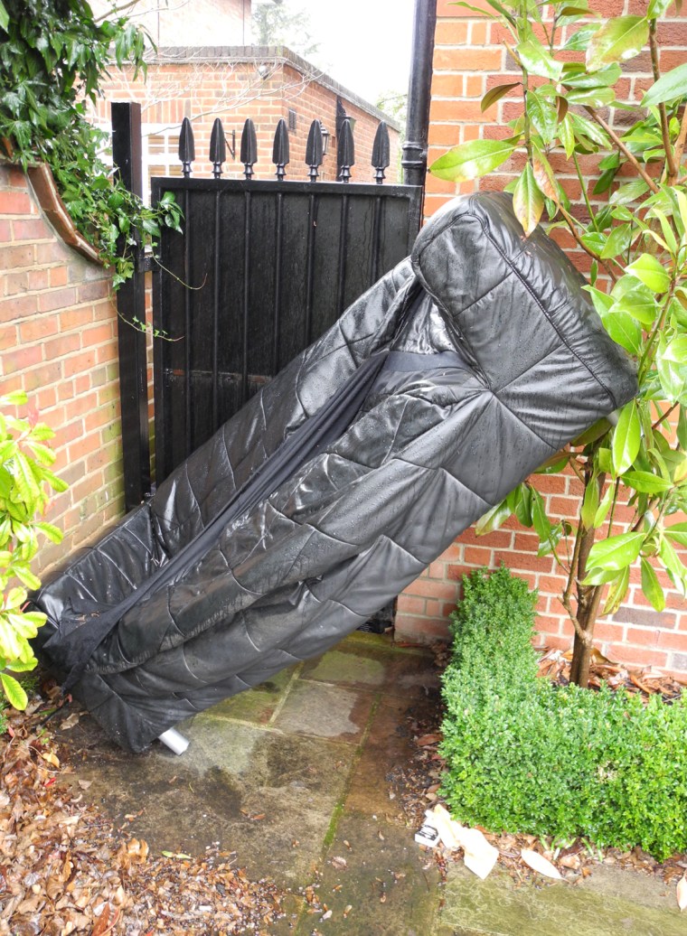 A discarded sofa blocks entry to a squatted home in Hampstead, London. The house is said to be owned by the Gadhafi family.