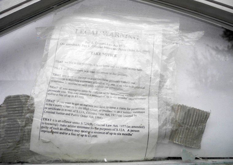 A notice posted at the door of a squatted home in Hampstead, London. The house is said to be owned by the Gadhafi family.