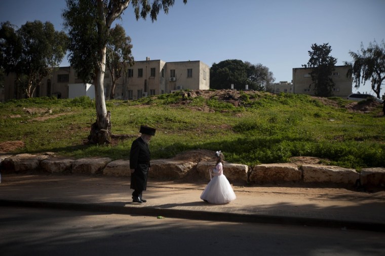 An Ultra Orthodox Jewish girl dressed as a bride during purim festival in the ultra-Orthodox town of Bnei Brak near Tel Aviv, Israel, Thursday, March. 8, 2012. The Jewish holiday of Purim celebrates the Jews' salvation from genocide in ancient Persia, as recounted in the Scroll of Esther.(AP Photo/Oded Balilty)