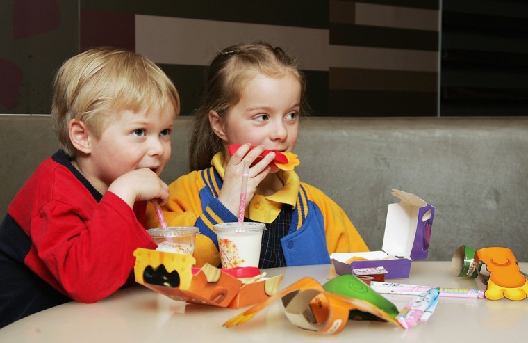 MELBOURNE, AUSTRALIA - AUGUST 29:  Children eat a new Happy Meal at the McDonald's restaurant in Collingwood on August 29, 2006 in Melbourne, Australia. The new Happy Meal is a low fat alternative to the fast food chain's traditional Happy Meal. Childhood obesity is a major health issue in Australia and has tripled in the last 20 years with one in six Australian children classed as obese.  (Photo by Kristian Dowling/Getty Images)