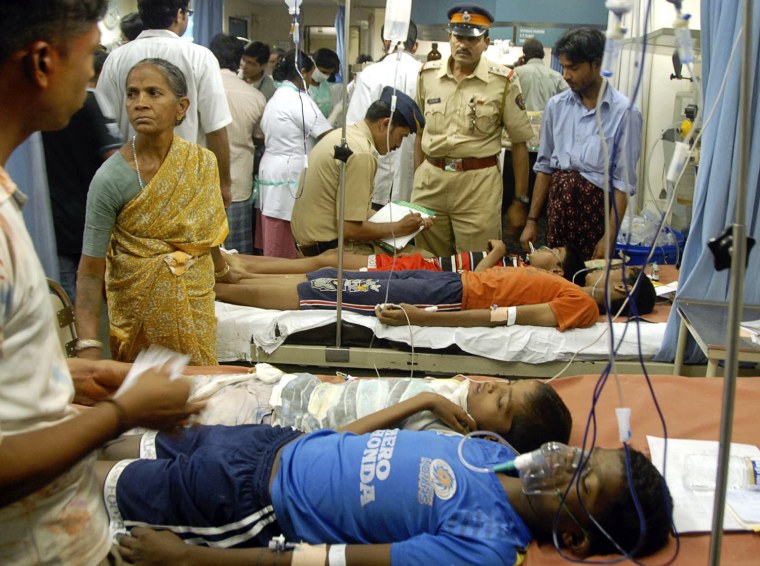 Police take notes as they speak to children suffering from poisoning from colored powder and water used during Holi celebrations, the Hindu festival of colors, in Mumbai, India, Thursday, March 8, 2012. More than 140 children from Dharavi area of Mumbai were hospitalized following poisoning from colored powder, according to a news agency. (AP Photo)