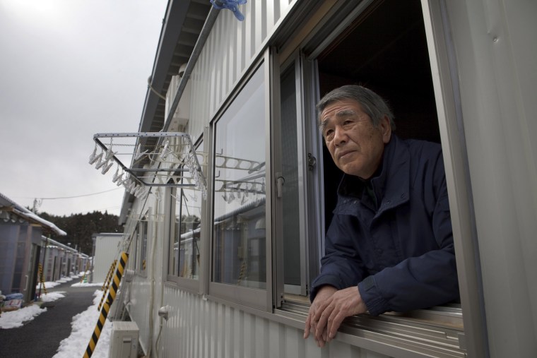 Katsushi Haga, 67, looks out window of his temporary house in Koizumi district of Kesennuma in Miyagi prefecture, Japan on Feb 27, 2012. The tsunami on March 11, 2011 flattened the district, destroying 266 of its 518 households and killed about 30 of its estimated 1,800 residents, including Haga’s 87-year-old mother, Tomiko. Photo by Kuni Takahashi