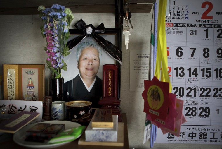 A photo of Katsushi Haga's mother, Tomiko, is placed at a shrine in Katsushi's temporary house in Koizumi district of Kesennuma in Miyagi prefecture, Japan on Feb 27, 2012. The tsunami on March 11, 2011 flattened the district, destroying 266 of its 518 households and killed about 30 of its estimated 1,800 residents, including Haga’s 87-year-old mother, Tomiko. Photo by Kuni Takahashi