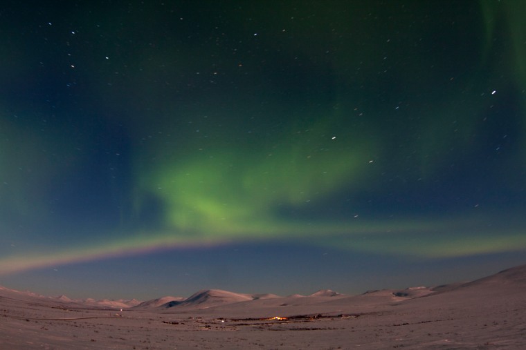 The aurora borealis is seen from Mile 7 on Beam Road above snow-covered tundras near Nome, Alaska March 10, 2012. A solar storm that shook the Earth's magnetic field on Thursday spared satellite and power systems as it delivered a glancing blow, although it could still intensify until early Friday, U.S. space weather experts said. REUTERS/Oscar Avellaneda-Cruz (UNITED STATES - Tags: ENVIRONMENT TPX IMAGES OF THE DAY)