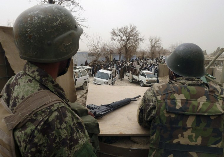 Afghan National Army soldiers keep watch inside a U.S. base in Panjwai district Kandahar province, March 11, 2012. Coalition forces killed 15 civilians in a shooting spree in Afghanistan's southern Kandahar province on Sunday, the defence ministry said, in an incident likely to deepen the growing divide between Washington and Kabul. REUTERS/ Ahmad Nadeem (AFGHANISTAN - Tags: CIVIL UNREST CRIME LAW)