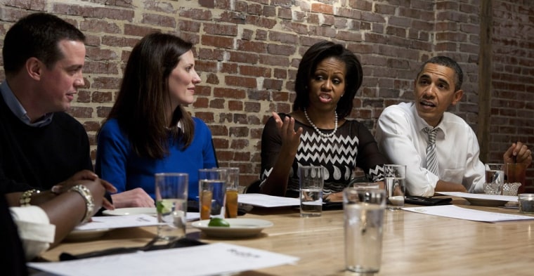President Barack Obama and first lady Michelle Obama attend dinner with Cathleen Loringer (2nd L), a former social worker from Wauwatosa, Wisconsin, and her guest John Loringer (L), an attorney from Wauwatosa, Wisconsin, and other winners of a campaign contest at a restaurant in Washington on March 8, 2012.