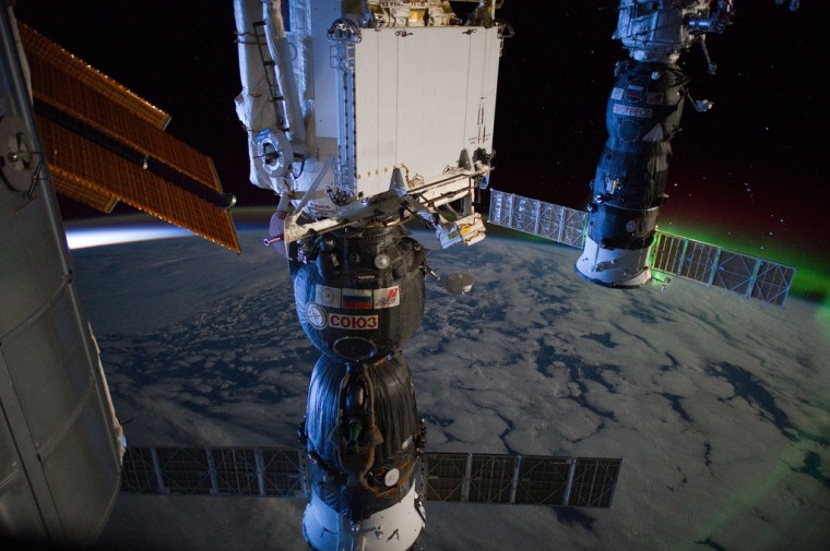 This March 6 photo from the International Space Station highlights daybreak on the left side of the horizon, and the southern lights on the right side. The station was flying over the Indian Ocean at the time, or about 1,200 miles south of Australia. The view is toward the east. A Russian Soyuz spacecraft is connected to the Pirs docking compartment at center, and a Russian Progress cargo craft is docked at right.
