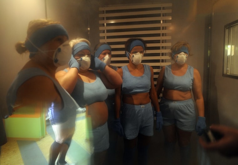 Women stand during a session in the cryotherapy room at the cryotherapy division of the Olympic Sports Centre in Spala, 100 kilometres (60 miles) southwest of the Polish capital Warsaw on March 7, 2012. The cryotherapy division has become legendary since Wales came here in June 2011 and four months later powered into the World Cup semi-finals in New Zealand. AFP PHOTO / JANEK SKARZYNSKI (Photo credit should read JANEK SKARZYNSKI/AFP/Getty Images)
