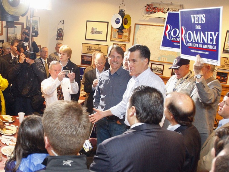Republican presidential candidate, former Massachusetts Gov. Mitt Romney greets supporters who braved the rain during a campaign stop at the Whistle Stop Cafe, Monday, March 12, 2012 in Mobile, Ala. (AP Photo/ John David Mercer)