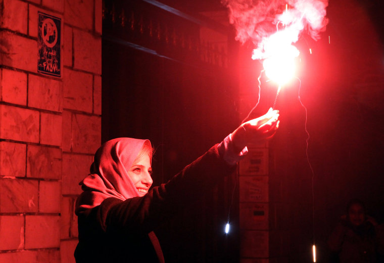 An Iranian woman holds a firecracker in Tehran on March 13, 2012 during the Wednesday Fire ritual, or Chaharshanbeh Soori, held on the last Wednesday eve before the Spring holiday of Noruz. The Iranian new year that begins on March 21 coincides with the first day of spring during which locals revive the Zoroastraian celebration of lighting a fire and dancing around the flame. AFP PHOTO/ATTA KENARE (Photo credit should read ATTA KENARE/AFP/Getty Images)