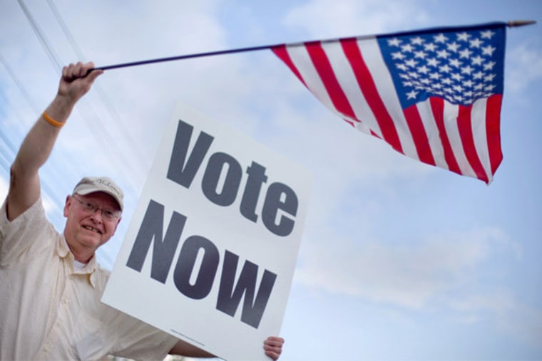 Danny Cooper waving to motorists outside a polling place in Vestavia Hills, Alabama on Tuesday.