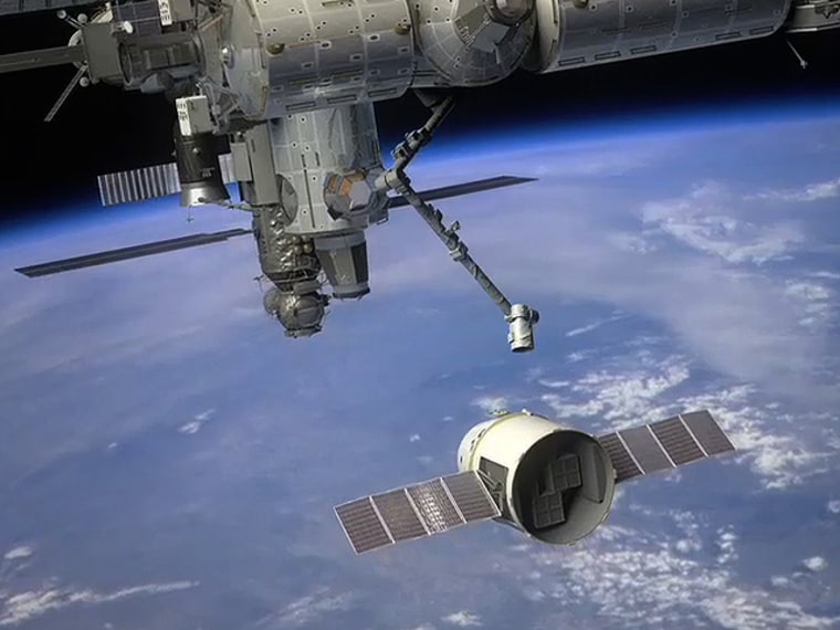 An artist's conception shows SpaceX's Dragon capsule approaching the International Space Station for a delivery.