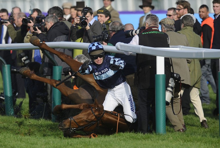 CHELTENHAM, ENGLAND - MARCH 14: Richard Johnson riding Wishful Thinking falls during The sportingbet.com Queen Mother Champion Steeple Chase at Cheltenham racecourse on March14, 2012 in Cheltenham, England. (Photo by Alan Crowhurst/Getty Images)