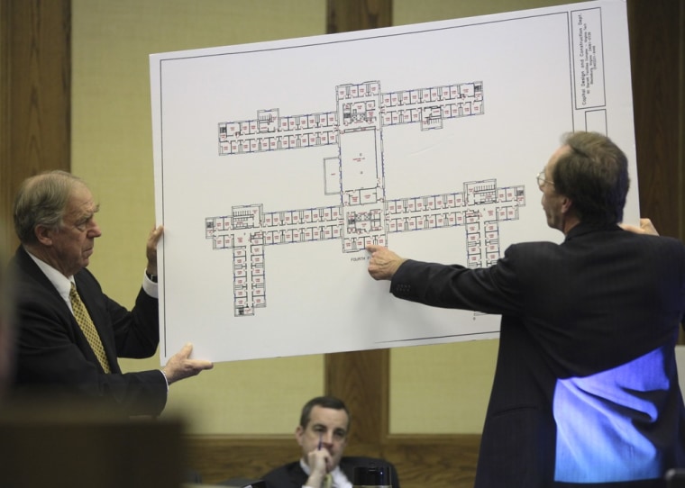 Defense attorneys Peter Messitt, right, and William “Bill” Broaddus, left, hold an enlarged map of the fourth floor of West Ambler Johnston Hall on the Virginia Tech campus in Montgomery County Circuit Court in Christiansburg, Va. onWednesday March 14 2012. Jurors began deliberating Wednesday over a lawsuit filed by the parents of two students slain in the 2007 Virginia Tech massacre claiming school officials botched their response when the first reports came in that a gunman was on campus. Attorneys for the university have countered that there was no way to anticipate the man who committed those first two killings April 16 in a dormitory would carry out the deadliest mass shooting in modern U.S. history. (AP Photo/The Roanoke Times, Matt Gentry)