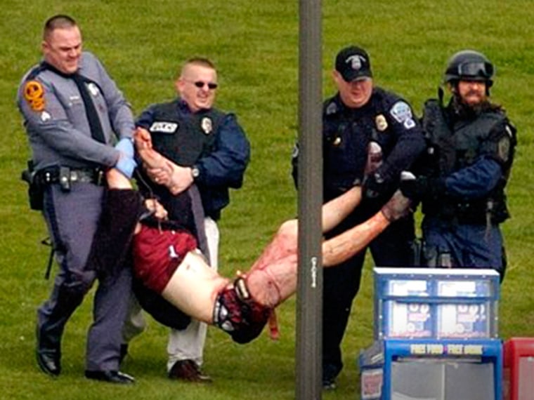 **EDS NOTE; GRAPHIC CONTENT**An unidentified person is carried out of Norris Hall at Virginia Tech in Blacksburg, Va., Monday, April 16, 2007, after a shooting incident. Shootings in a dorm and classroom at Virginia Tech resulted in multiple fatalities. (AP Photo/The Roanoke Times, Alan Kim) ** MAGS OUT, NO SALES**