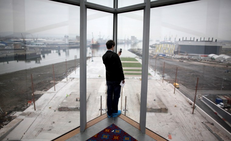 BELFAST, NORTHERN IRELAND - MARCH 13: (EDITORS NOTE: IMAGES OF TITANIC BELFAST ARE EMBARGOED UNTIL 1700 hrs ON MARCH 14, 2012) A visitor takes a phone picture of the slipway at the Titanic Belfast attraction on March 13, 2012 in Belfast, Northern Ireland. The Titanic Belfast Experience is a new £90 million visitor attraction which opens on March 31, 2012. The ill-fated passenger liner sank after hitting an iceberg in the Atlantic on the night of April 15, 1912 with the loss of 1517 lives. (Photo by Peter Macdiarmid/Getty Images)