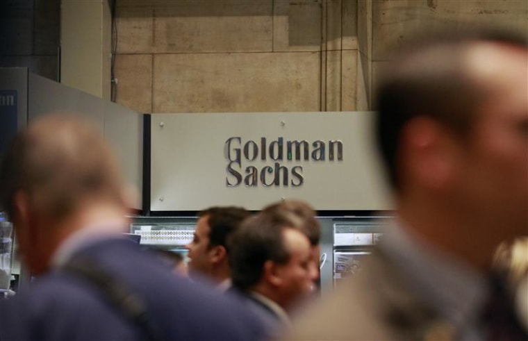 Traders work on the floor of the New York Stock Exchange near the Goldman Sachs stall in this July 16, 2010 file photograph. Goldman Sachs faced an unprecedented assault from one of its own on March 14, 2012, after a banker published a withering resignation letter in the New York Times, calling the Wall Street titan a