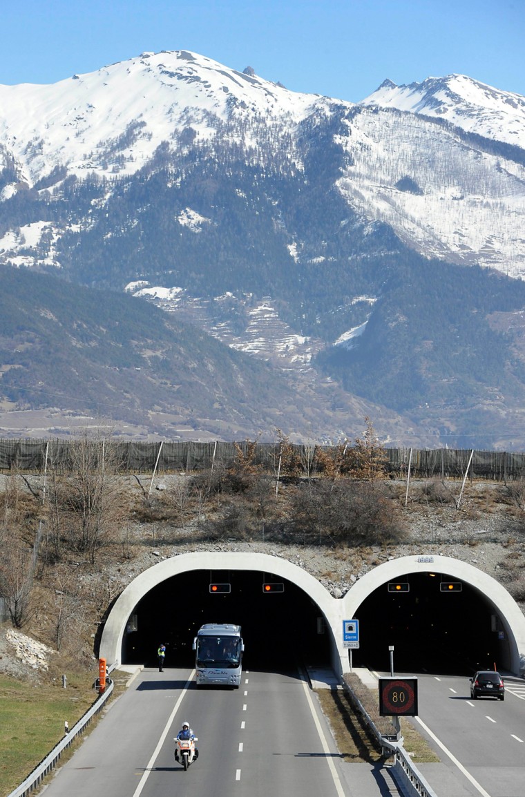 A bus with the relatives of victims leaves the tunnel after they paid tribute at the site of the accident in Sierre, western Switzerland, Thursday, March 15, 2012. Twenty-eight people, including 22 children, returning to Belgium from a skiing holiday died in a bus accident in Sierre in the Swiss canton of Valais, Swiss police said Wednesday. (AP Photo/Keystone, Olivier Maire)