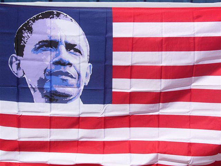 A Stars and Stripes flag featuring a portrait of President Barack Obama.