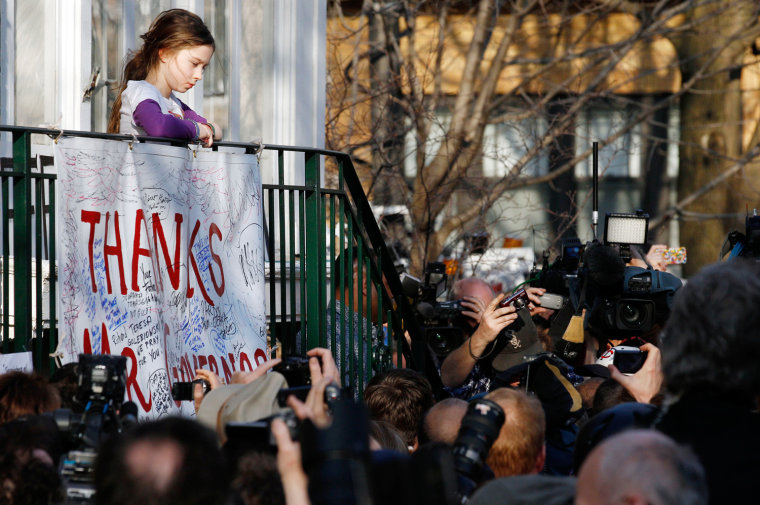 Annie Blagojevich, daughter of former Illinois Gov. Rod Blagojevich, watches as her father is surrounded by the media in front of their home Wednesday, March 14, 2012 in Chicago. The 55-year-old Democrat is due to report to a prison in Colorado on Thursday to begin serving a 14-year sentence, making him the second Illinois governor in a row to go to prison for corruption. (AP Photo/M. Spencer Green)