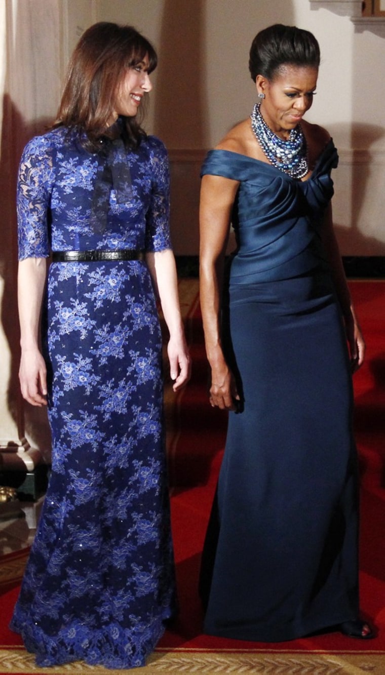 U.S. first lady Michelle Obama and Samantha Cameron, wife of British Prime Minister David Cameron, walk into the State Dinner at the White House in Washington March 14, 2012. REUTERS/Kevin Lamarque (UNITED STATES - Tags: POLITICS ENTERTAINMENT)