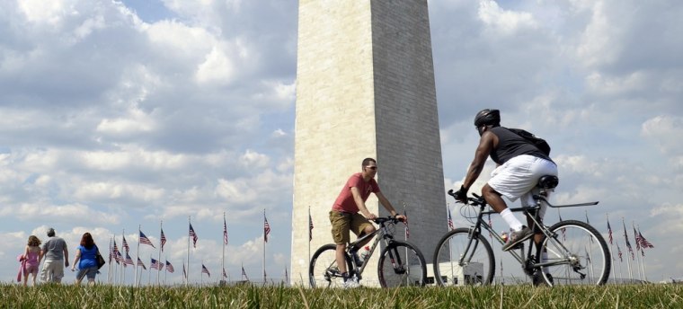 People enjoy the warm weather near the Washington Monument in Washington, Thursday, March 15, 2012. (AP Photo/Susan Walsh)