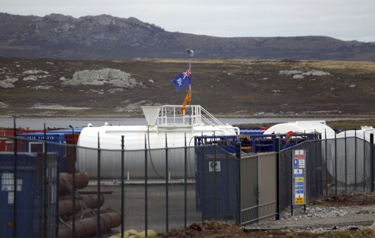 The Falkland Islands flag blows in the wind at a depot for machinery and equipment used in oil exploration is seen in Port Stanley on Tuesday. Argentina will take legal action against any companies involved in oil exploration in the Falkland Islands, Foreign Minister Hector Timerman said on Thursday.