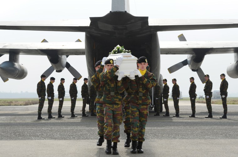 In this handout photo released by the Belgian Department of Defense, soldiers unload coffins of children and teachers who were killed in a deadly bus crash in Switzerland, at the military airport of Melsbroek, Belgium, Friday, March 16, 2012. A coach accident in Switzerland on Wednesday left 28 dead, including 22 children traveling home after a skiing holiday. (AP Photo/Belgian Defense Department)