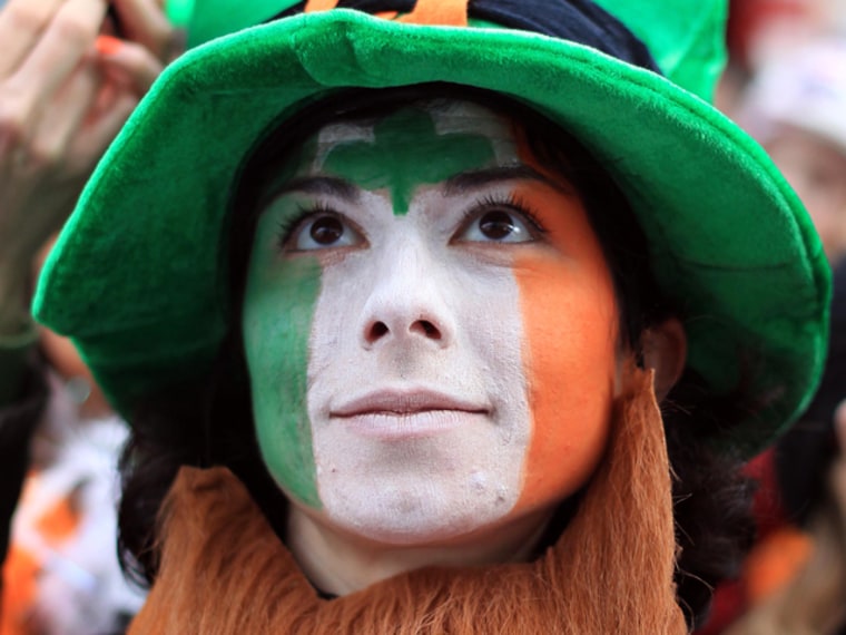 A parade goer watches a float during the St Patrick's Day festivities in Dublin, Ireland on March 17, 2012. More than 100 parades are being held across Ireland to mark St Patrick's Day, with up to 650,000 spectators expected to attend the parade in Dublin. AFP PHOTO/ PETER MUHLY (Photo credit should read PETER MUHLY/AFP/Getty Images)