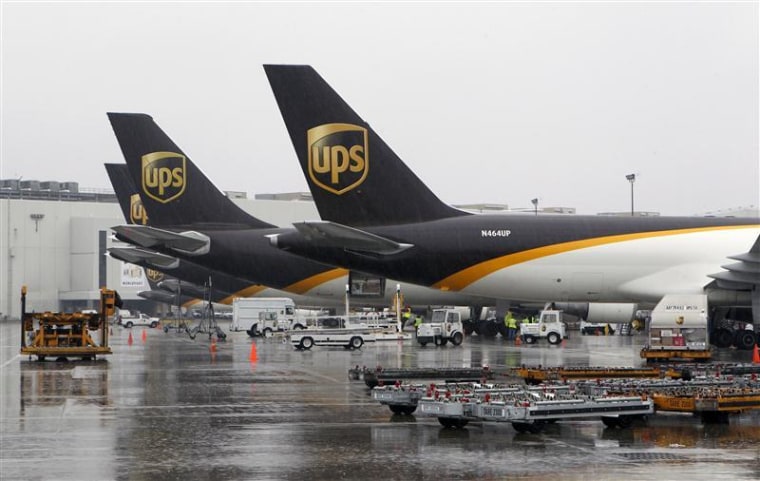 United Parcel Service cargo aircraft are loaded with air containers full of packages bound for their final destination at the UPS Worldport All Points International Hub during the peak delivery day in Louisville, Kentucky, December 22, 2011. REUTERS/John Sommers II
