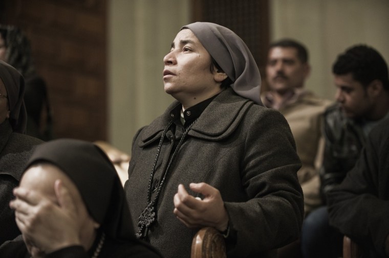 Egyptian Christian Coptic nuns mourn the death of Pope Shenuda III, the spiritual leader of the Middle East's largest Christian minority, in Saint Mark's Coptic Cathedral in Cairo's al-Abbassiya district, on March 19, 2012. Pope Shenuda died at the age of 88, after a long battle with illness and based on his wishes he will be buried on March 20, at Saint Bishoy monastery in Wadi Natrun in the Nile Delta where he spent his time in exile after a dispute with late president Anwar Sadat. AFP PHOTO/GIANLUIGI GUERCIA (Photo credit should read GIANLUIGI GUERCIA/AFP/Getty Images)