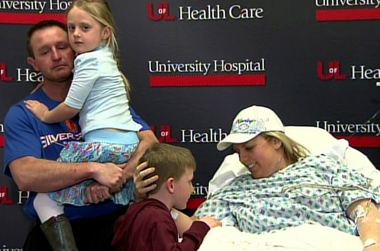 'There is nothing you won't do for them': Stephanie Decker with her son Dominic, daughter Reese, and husband Joe in the hospital, after she lost one foot and one leg shielding her children from a deadly tornado.