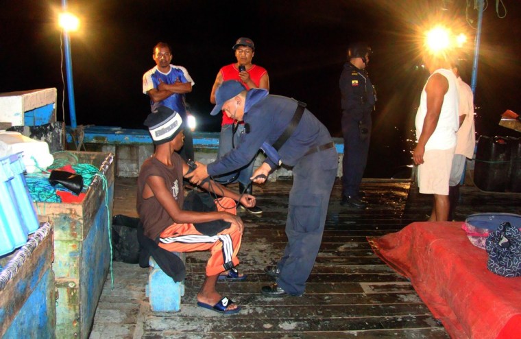 In this photo released by Ecuador's navy, Panamanian fisherman Adrian Vasquez, bottom left, an 18-year-old Panamanian who worked as a maid in a seaside resort hotel, receives medical attention aboard the Duarte V, a fisherman boat, offshore Galapagos Islands, Ecuador, Sunday, March 25, 2012. Vasquez, who took up an offer by two friends to join them on a fishing trip and earn some extra cash, was rescued at sea north of the Galapagos on Friday March 23, 2012 by the Duarte V after he and the two companions, who were found dead, had been missing since Feb. 24. (AP Photo/Ecuador's navy)