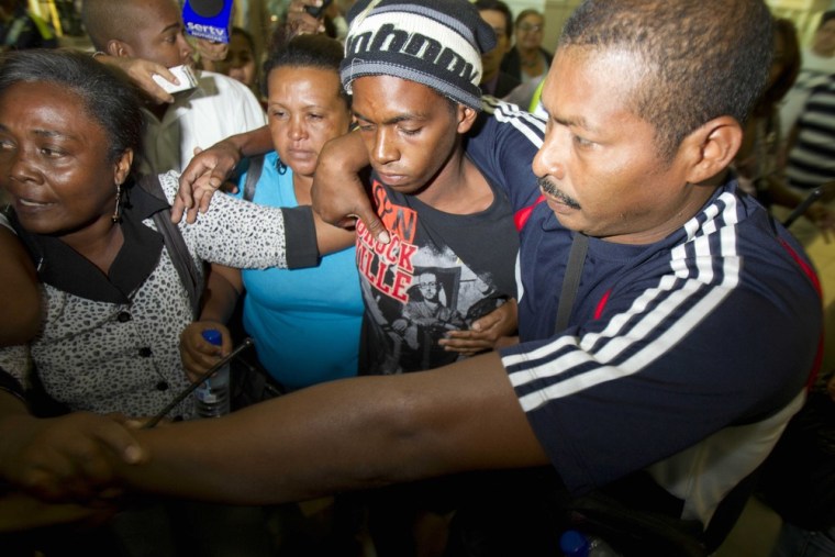 Rescued castaway Adrian Vasquez, second from right, is surrounded by family members upon his arrival to Tocumen international airport in Panama City, Tuesday, March 27, 2012. Vasquez, an 18-year-old Panamanian who worked as a maid in a seaside resort hotel, took up an offer by two friends to join them on a fishing trip and earn some extra cash, was rescued at sea north of the Galapagos on Friday March 23, 2012 by another fishing boat after he and the two companions, who were found dead, had been missing since Feb. 24. (AP Photo/Arnulfo Franco)