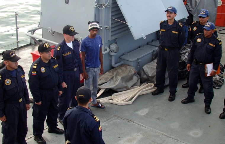 In this photo released by Ecuador's navy, Adrian Vasquez, center, an 18-year-old Panamanian who worked as a maid in a seaside resort hotel, poses with Ecuadorean sailors onboard a navy ship offshore Galapagos Islands, Ecuador, Monday, March 26, 2012. Vasquez, who took up an offer by two friends to join them on a fishing trip and earn some extra cash, was rescued at sea north of the Galapagos on Friday March 23, 2012 by another fishing boat after he and the two companions, who were found dead, had been missing since Feb. 24. (AP Photo/Ecuador's navy)