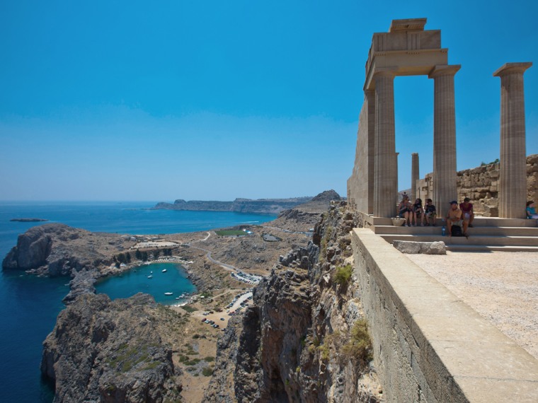 RHODES, GREECE - JUlLY 04: Tourists at Athena-Lindia-Temple at the Acropolis of Lindos on July 04, 2010 in Lindos, Greece. The old town of Lindos is famous for the ancient Acropolis. The Akropolis is built on a 116 Meter high hill overlooking Lindos and the aegean sea and is listed at the  Unesco World Heritage. Rhodes is the largest of the Greek Dodecanes Islands. (Photo by EyesWideOpen/Getty Images)