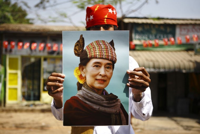 A supporter holds up a portrait of Myanmar pro-democracy leader Aung San Suu Kyi during an election campaign of the National League for Democracy (NLD) party in Yangon March 28, 2012. Myanmar's parliamentary election is scheduled for Sunday. REUTERS/Staff (MYANMAR - Tags: POLITICS ELECTIONS)