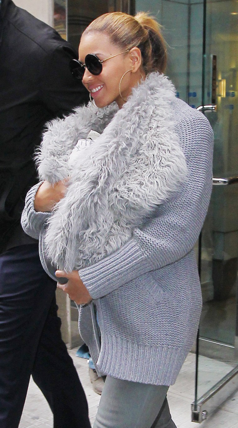 Hot mama! Beyonce snuggles Blue Ivy in faux fur sling?