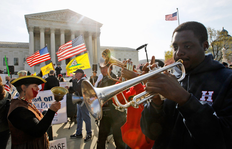 Jonathan Neal, a senior at Howard University, plays his trumpet in support of health care reform in front of the Supreme Court in Washington, on March 28, on the final day of arguments regarding the health care law signed by President Barack Obama.