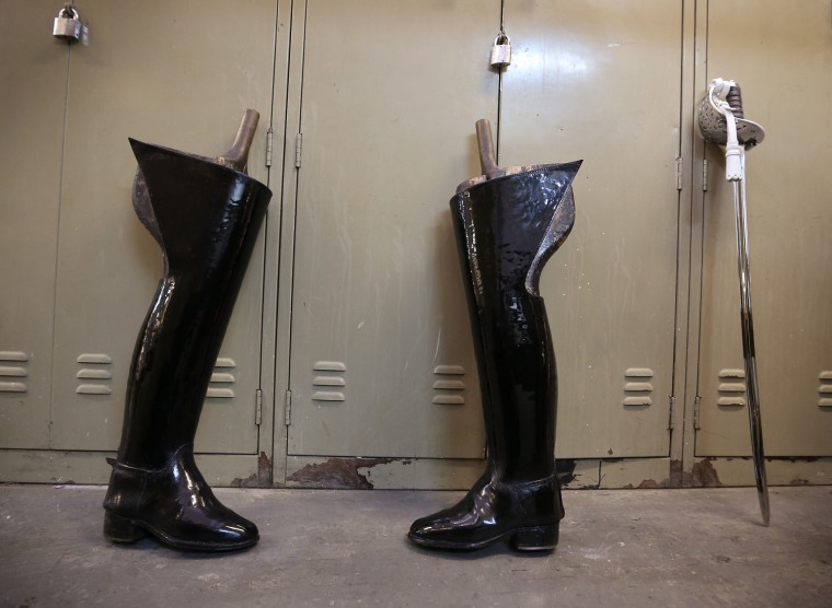 Riding boots and a ceremonial sword await cleaning at The Household Cavalry Mounted Regiment Hyde Park Barracks.
