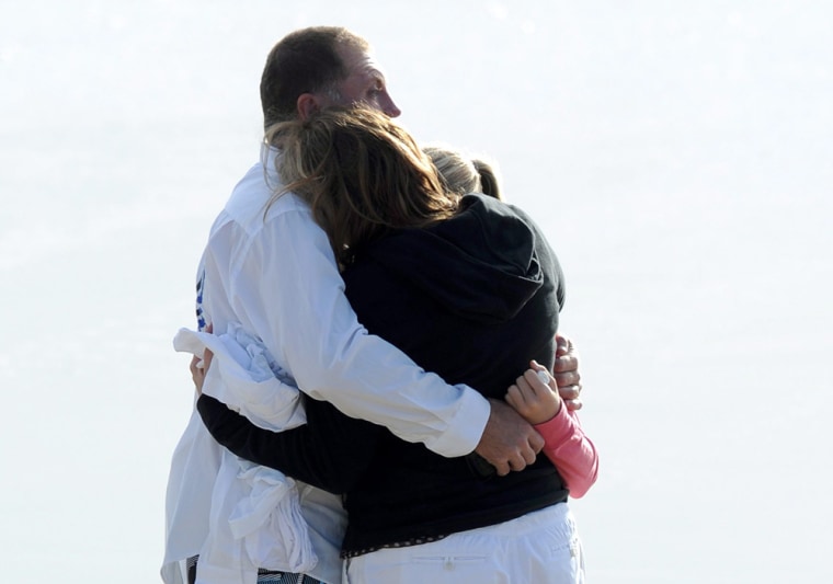 Family members believed to be the parents of 14 year old Matt Barclay mourn his death at Kurrawa beach on the Gold Coast, Australia on Thursday, March 29, 2012.