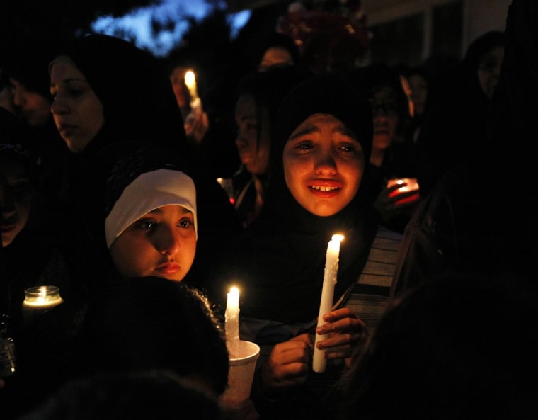 Mourners hold a candlelight vigil to remember Shaima Alawadi outside her home in El Cajon, California March 28, 2012. Alawadi, a 32-year-old Iraqi-American woman, died of her wounds on Saturday after being severely beaten in her home by a killer who left a threatening note that prompted police to investigate the murder as a possible hate crime.