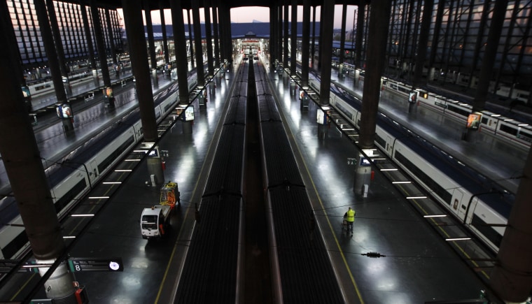A worker walks past AVE high-speed trains at Madrid's Atocha station during a general strike in Spain March 29, 2012. Spanish unions said a high turnout for a general strike to protest government budget cuts and reforms on Thursday had almost brought heavy industry to a halt while the government said the day was proceeding normally.