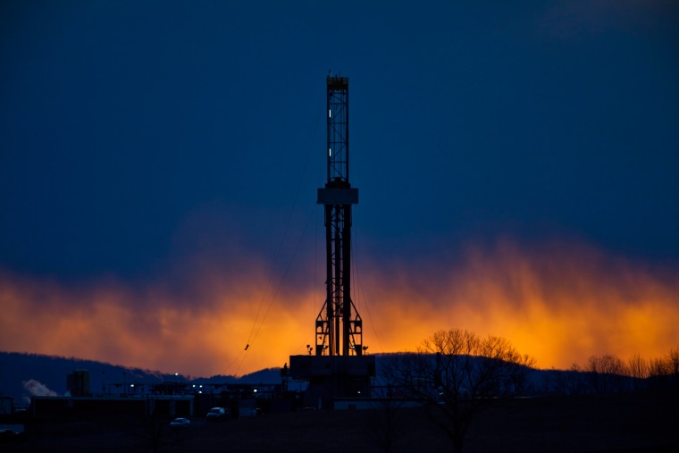 A hydraulic fracturing drill rig at dusk near Tunkhannock, Pennsylvania, March 9. The drilling practice requires injecting huge amounts of water, sand, and chemicals at high pressure thousands of feet beneath the earth's surface to extract reserves of natural gas.