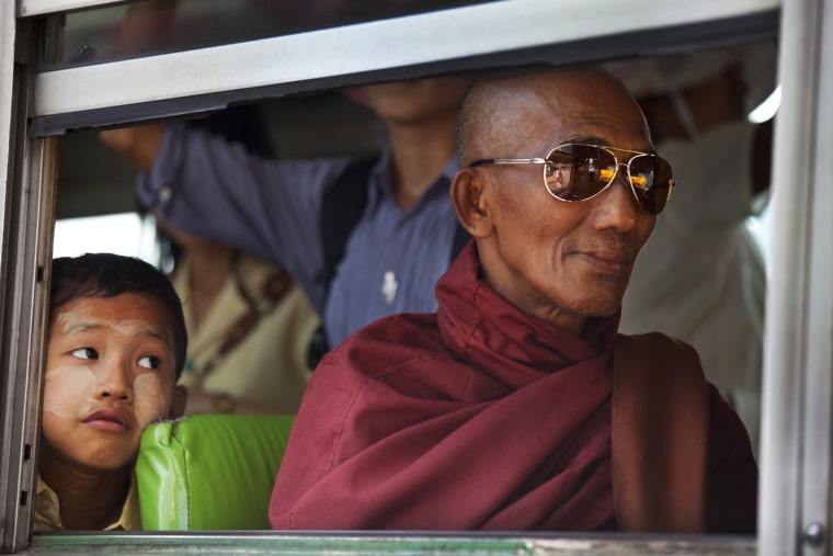 A Burmese monk rides a city bus as a young boy looks on ahead of the parliamentary elections on March 29, in Yangon, Myanmar. The upcoming vote is seen as an important vote of confidence for the country as it continues on the road to political and diplomatic reform. Democracy icon Aung San Suu Kyi has fallen ill while campaigning for Myanmar's upcoming by-elections and has currently suspended her tour days ahead of the polls according to medical advice.