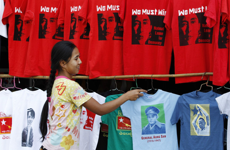 A Burmese seller adjusts t-shirts supporting the vote for Aung San Suu Kyi, democracy campaigner and leader of the National League for Democracy (NLD) party, at a shop in Yangon, Myanmar, on 29 March. A new wave of reform in Myanmar is taking place ahead of parliamentary by-elections scheduled for 01 April, in which Aung San Suu Kyi will contest in the rural constituency of Kawmhu, south of Yangon. Her father General Aung San, who was assassinated by rivals in 1947, is seens on T-shirt on the right.